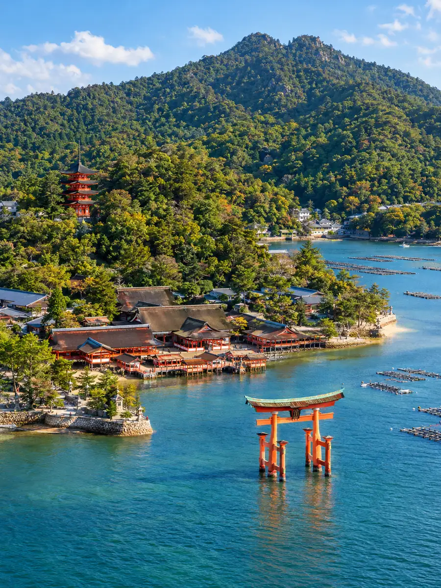 Die Insel Miyajima aus der Luft, mit dem Itsukushima-Schrein am Ufer und dem Torii in der Bucht